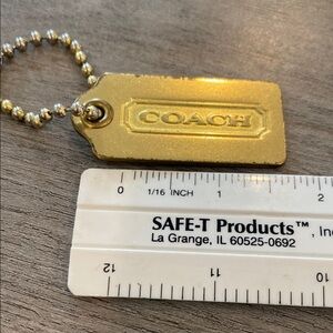 Coach Goldtone metal hang tag